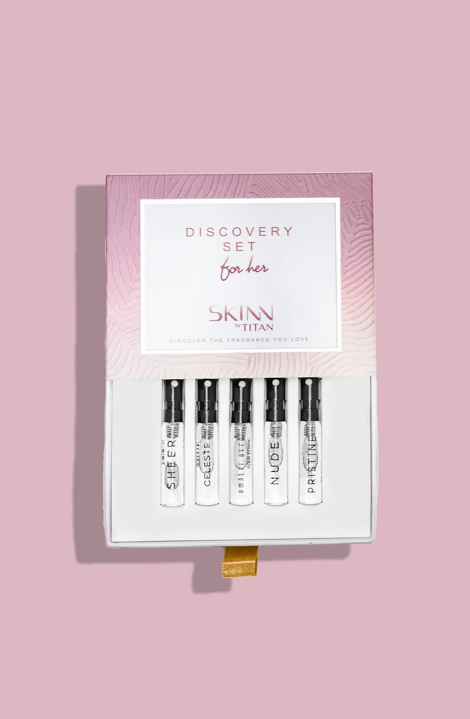 An overhead view of the open SKINN by TITAN 'Discovery Set for her', showing the five fragrance samples nestled inside the pink-branded box.